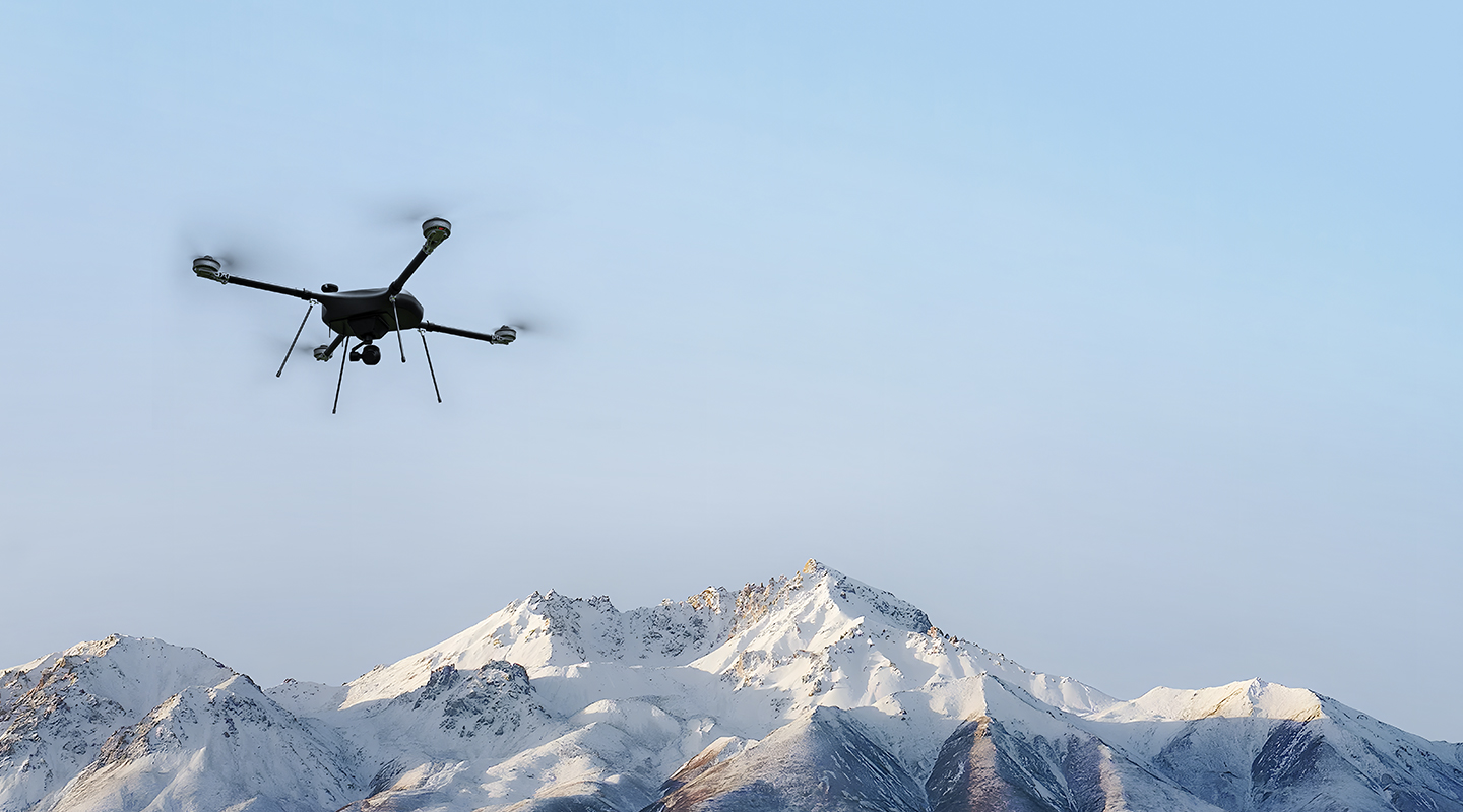 Drone inspecting power grids in mountain area